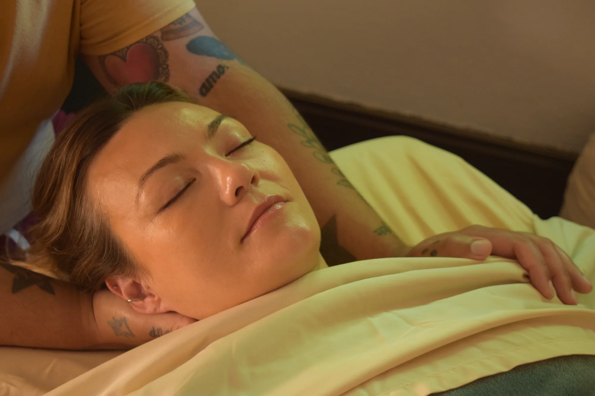 A client resting comfortably during a quiet massage moment.