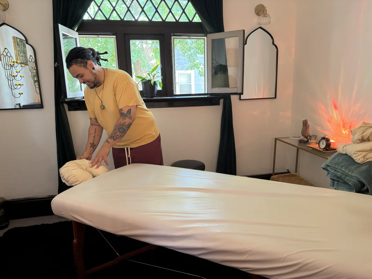 Jonathan thoughtfully preparing the massage table before a client arrives.