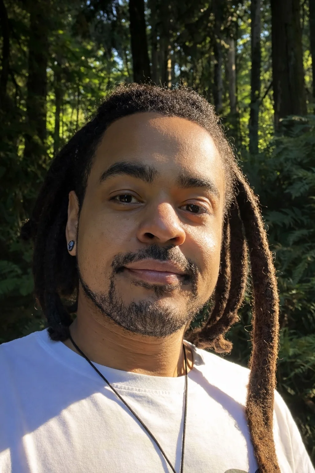 Jonathan Cuskey in a sunlit Portland forest.